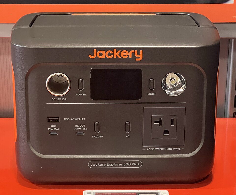 A dark gray Jackery Explorer 300 Plus power station with a display, USB ports and an AC outlet on the front, for storm prep in Coralville, IA