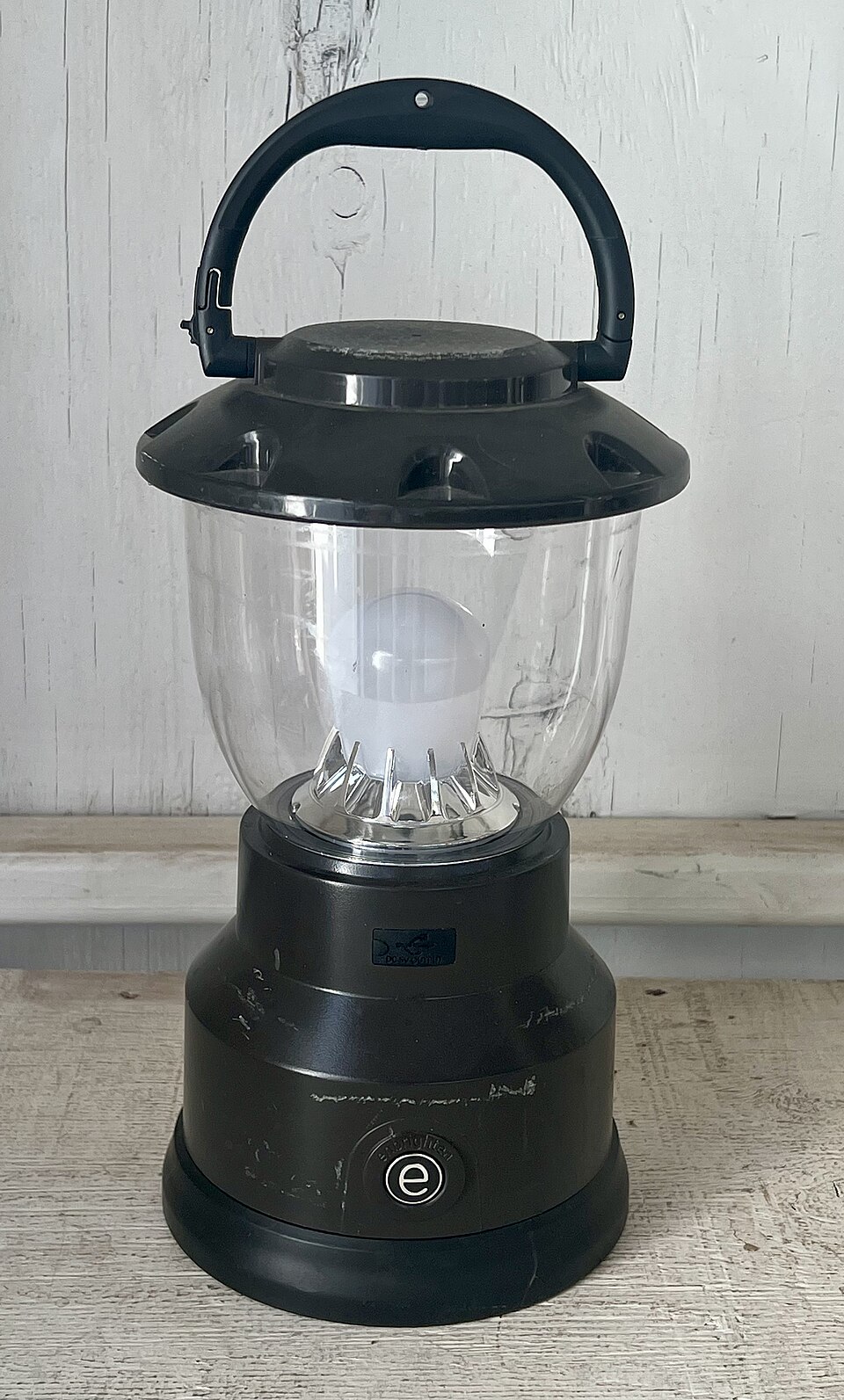 A black LED camping lantern with a clear globe and a top carry handle, for storm prep in Coralville, IA