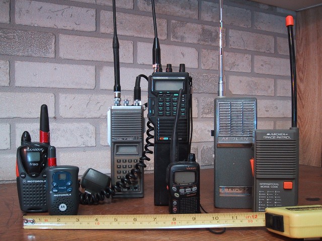 Several handheld walkie-talkies of different makes standing side by side, for storm prep in Coralville, IA
